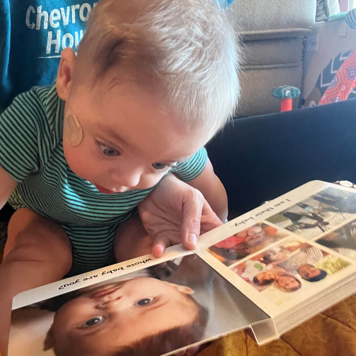 Picture of 10 month old looking at book